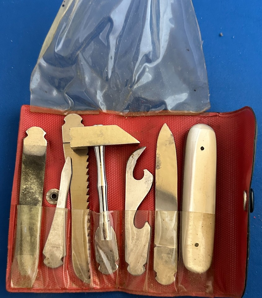 A full 7-piece 1960s Japanese pocket survival kit in its original black case — a complete time-capsule set that looks straight out of a Cold War spy film.