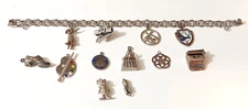 Sterling Silver Elco 10 charm Bracelet, Creel Epcot Hula Girl Cape Cod Ohio etc.