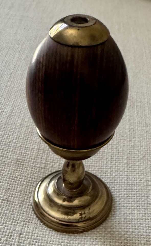 Van Cort egg-shaped brass kaleidoscope on a stand — a named vintage brand with a sculptural silhouette that doubles as art.