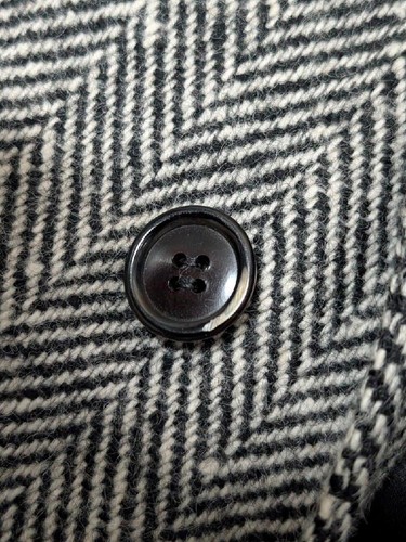 Black button with two front holes on cream and gray herringbone TWEED coat, 1960s-70s.