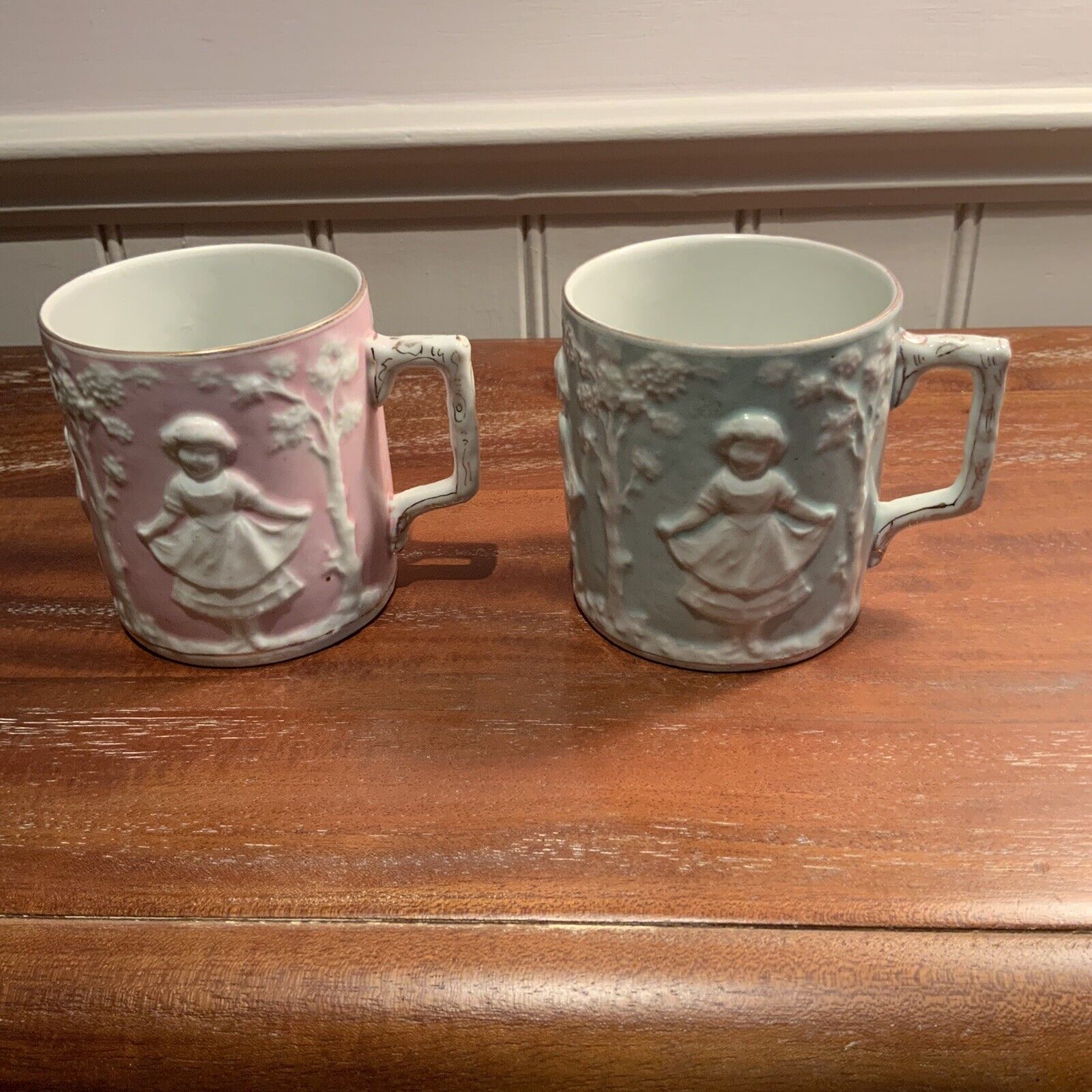 Matching Pair Of Vintage Mugs With Decorative Mouldings Pink and Blue