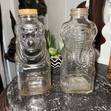 2 Vtg 1950s Grapette Soda Syrup Glass Elephant Clown and Coin Bank Bottle Camden