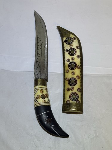 Nepalese Kukri knife featuring a curved blade and a distinct, ornate scabbard.