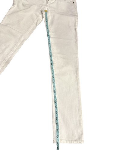 White AG Adriano Goldschmied jeans leg, 25R, with blue denim measuring tape along the waistband.