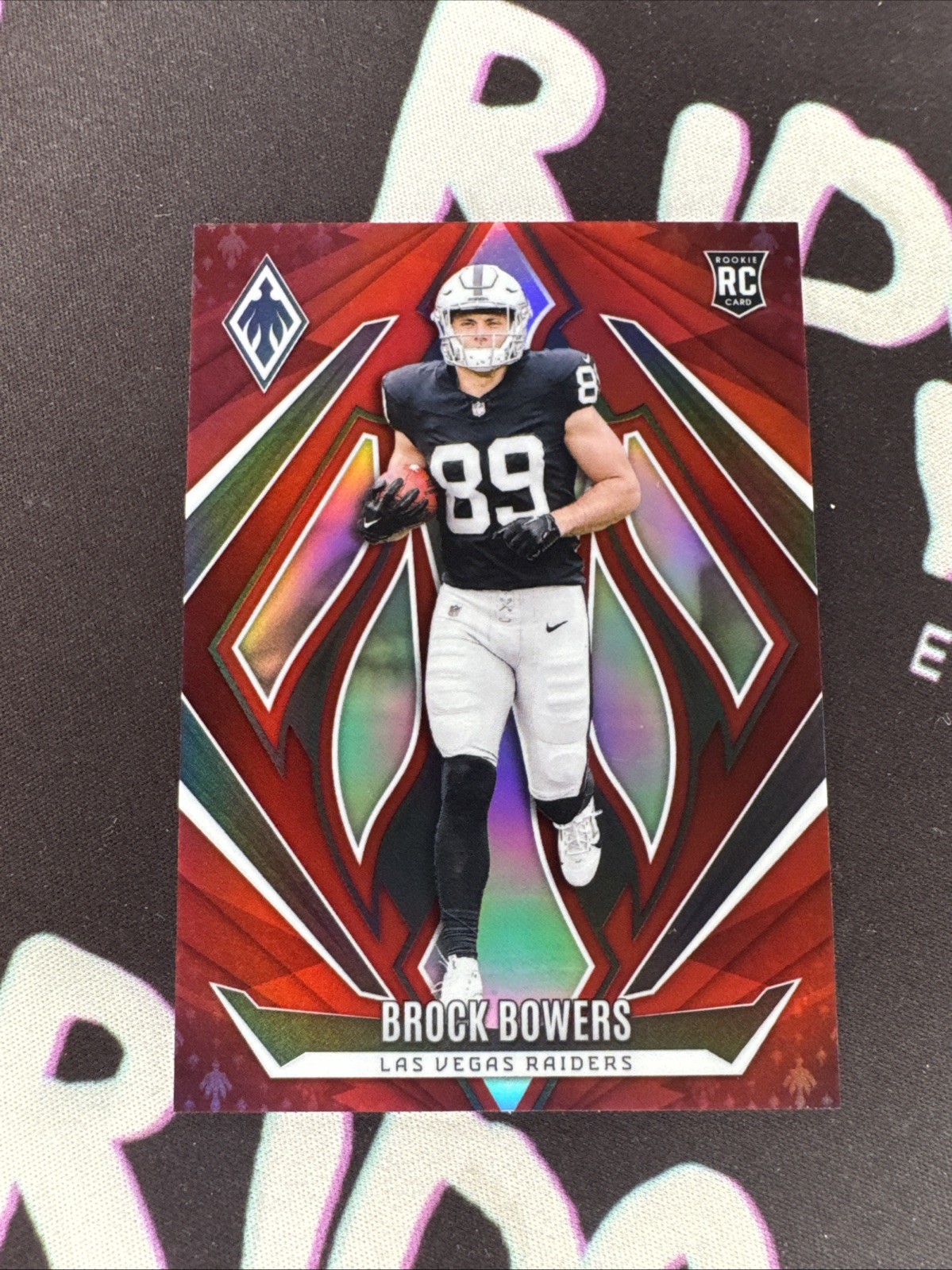 2024 Panini Phoenix Brock Bowers #165 Rookie Red /99 (RC) Las Vegas Raiders
