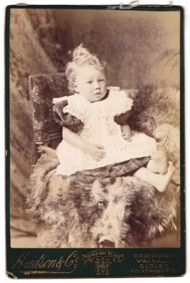Photograph Hudson & Co., Birmingham, baby in dress with sad look 