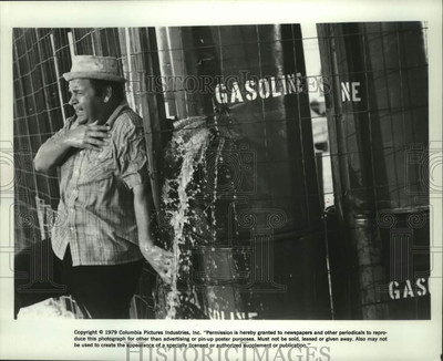 #ad 1979 Press Photo Dom DeLuise hides by barrels of gasoline in movie quot;Hot Stuff.quot; $24.99