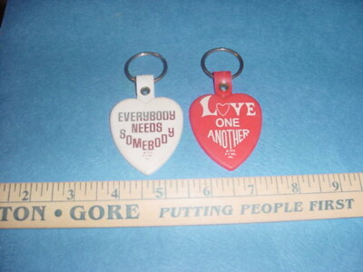 VINTAGE 1975 PEACE KEYCHAIN LOT OF 2 LOVE ONE ANOTHER EVERYBODY NEEDS SOMEBODY