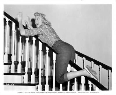 Dorothy Malone sliding down staircase railing for the film Written- Old Photo
