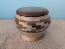 Hand carved segmented wooden lidded bowl and signed