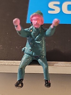 Unbranded Extremely Small Male Figure Sitting In Green .5 Inches