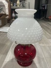 vintage ruby red oil lamp featuring a milk white glass hobnail shade