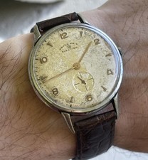 Reloj suizo vintage Grand Prix Election jumbo pátina tropical cuerda manual