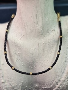 Authentic Ettika braided black leather chokers features gold-plated metal accents.