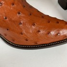 Brown ostrich quill leather women's cowboy boots with pointed toes and dark brown soles, featuring stitched seams.