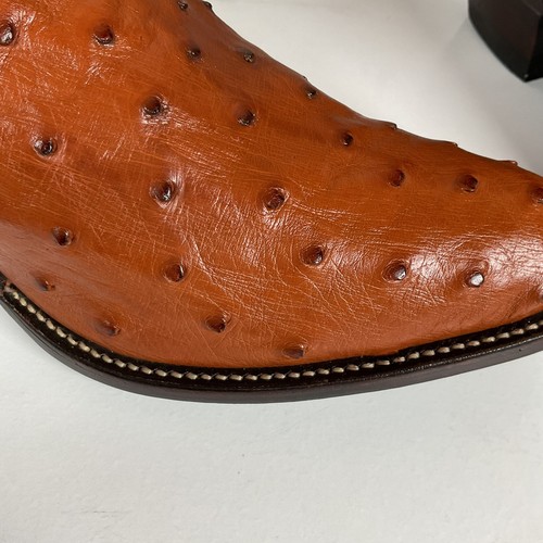 Brown ostrich quill leather women's cowboy boots with pointed toes and dark brown soles, featuring stitched seams.