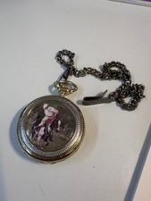 A gold-toned pocket watch with a jockey and Horse Scene dial