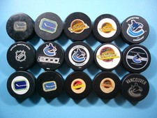 LOT 15 1970'S - 2010'S VANCOUVER CANUCKS NHL HOCKEY PUCKS COLLECTION SKATE LOGO