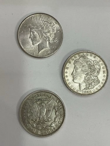 Lot of 3 - 90% Silver Dollars: 1927 Peace AU, 2-1921 Morgan’s .77344 Oz in Each