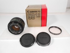 Canon FD 50mm 1:1.8 Lens with 2 Lens Caps and Promaster Spectrum 7 52 mm Filter.