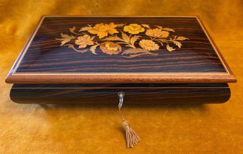 Hand-inlaid Sorrento marquetry meets Swiss REUGE mechanics — this is the gold standard of vintage music boxes, playing Edelweiss with old-world craftsmanship you simply can't find new.