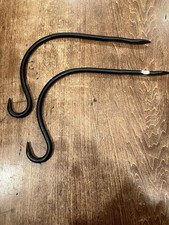 A Set Of Black Wrought Iron Hooks Or Hangers