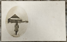 Young Girl Standing In Snow in Front of Farm Barn Velox RPPC Postcard B743