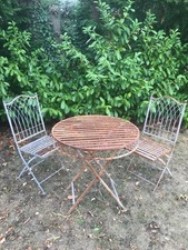 An iron garden folding table & 2 chairs requires repainting.