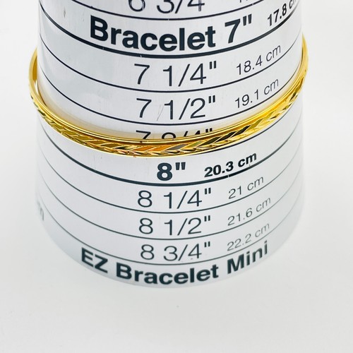 Lote de 2 brazaletes tono dorado con incrustaciones de cristal facetado texturizado y negro - Imagen 4 de 10