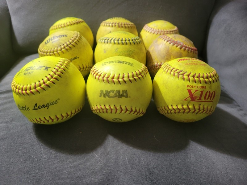 9 used yellow 12" softballs great for practice