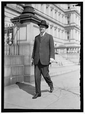 Photo:Man in Suit and Hat Walking Outside Government Building 1913-1917