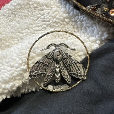 The silver luna moth necklace is a beautiful handmade
