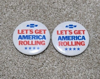 Two (2) 1981 Chevrolet Let's Get America Rolling Car Dealership Advertising Pins