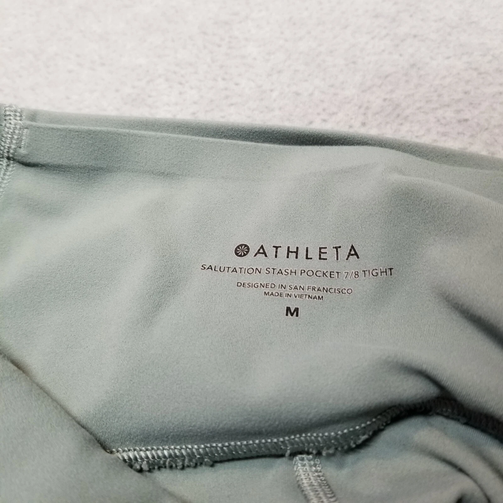 athleta salutation stash pocket 7/8 tight leggings