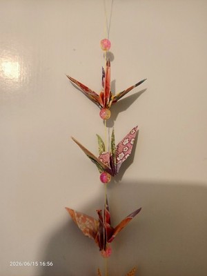 Pretty and colourful stringed origami paper crane. Nice gift idea.