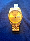 Dressy men's vintage Seiko quartz round face with day/date gold fluted dial
