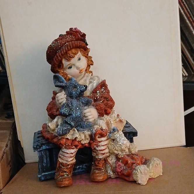 Multicolor Resin Girl Figurine Sitting on Bench Holding Doll