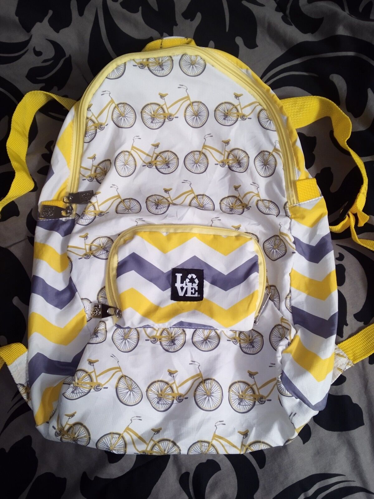 LOVE Stash It backpack in limited edition "Pedal Power" print, yellow