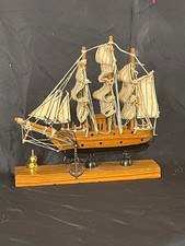 Small vintage wooden sailboat on stand. HMS Bounty style