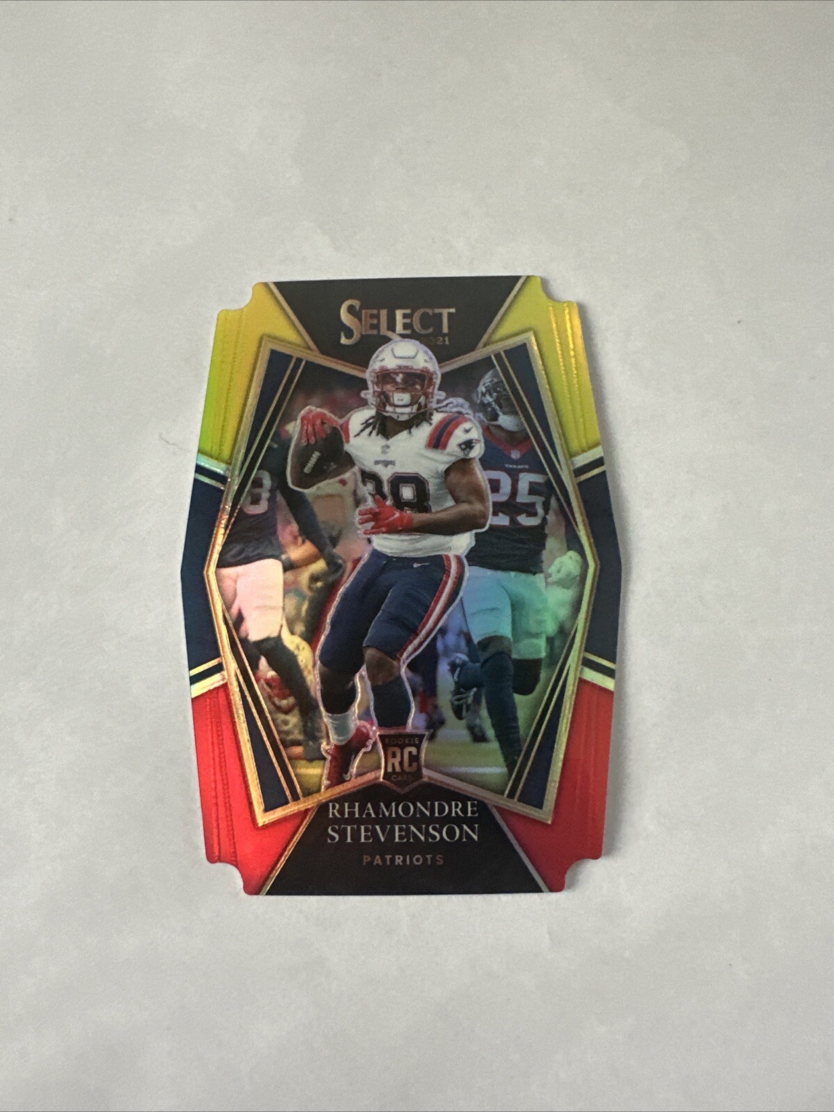 Rhamondre Stevenson 2021 Panini Select #75 RC Red & Yellow Die-Cut Patriots