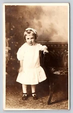 RPPC little girl bow white dress standing Postcard Portrait Real Photo Vtg