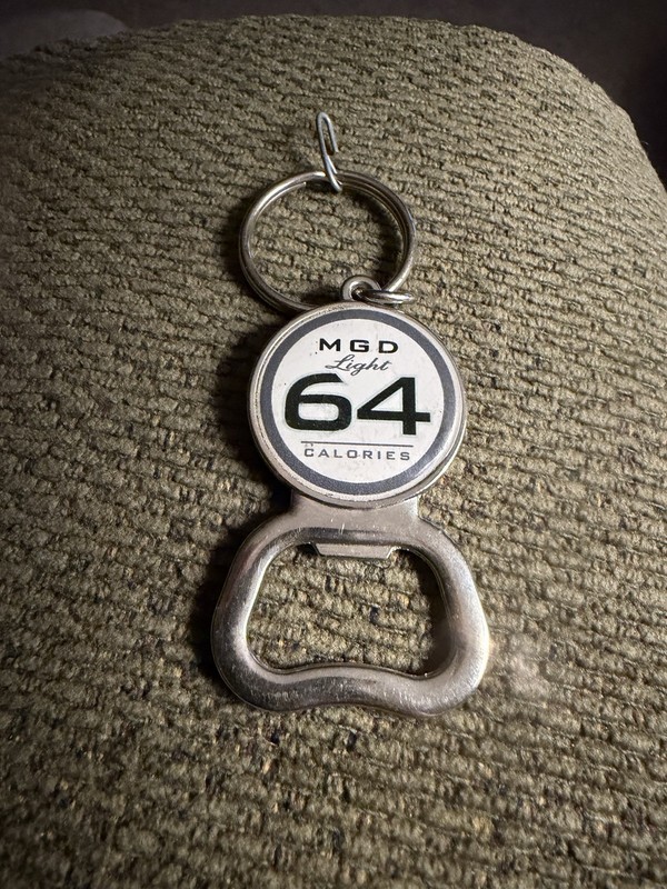 MGD light 64 calories bottle opener keychain in Used/ Excellent Condition.