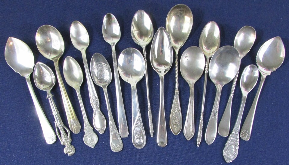 A set of 17 mismatched vintage silverplate novelty spoons — endlessly useful for crafting, jewelry-making, or displaying as curious art objects.