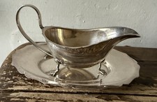 ANTIQUE SILVER PLATED SAUCE BOAT ON 3 FEET WITH SCROLL HANDLE,  AND SAUCER