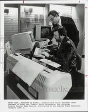 Press Photo Computerland salesman demonstrates computer for customer.