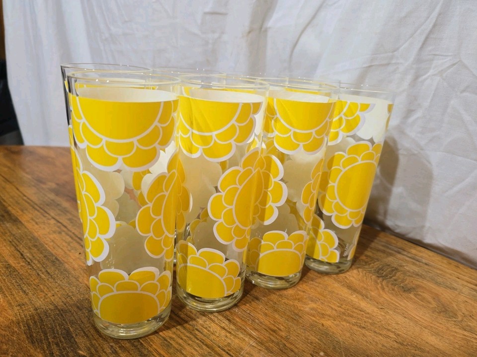 Eight Colony yellow mod flower-power Collins glasses — a full MCM set in a bold 60s graphic style that's impossible to find and immediately brightens any bar cart.