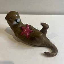 Ankyo Otter hard plastic figure holding a starfish lying on back 6" long 