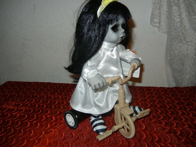 scary doll on tricycle