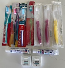 7 brand new tooth brushes, 2 travel size tubes of toothpaste 2 rolls of floss