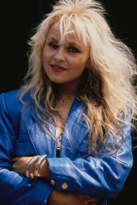 German heavy metal singer Doro Pesch her arms crossed wearing a bl- Old Photo